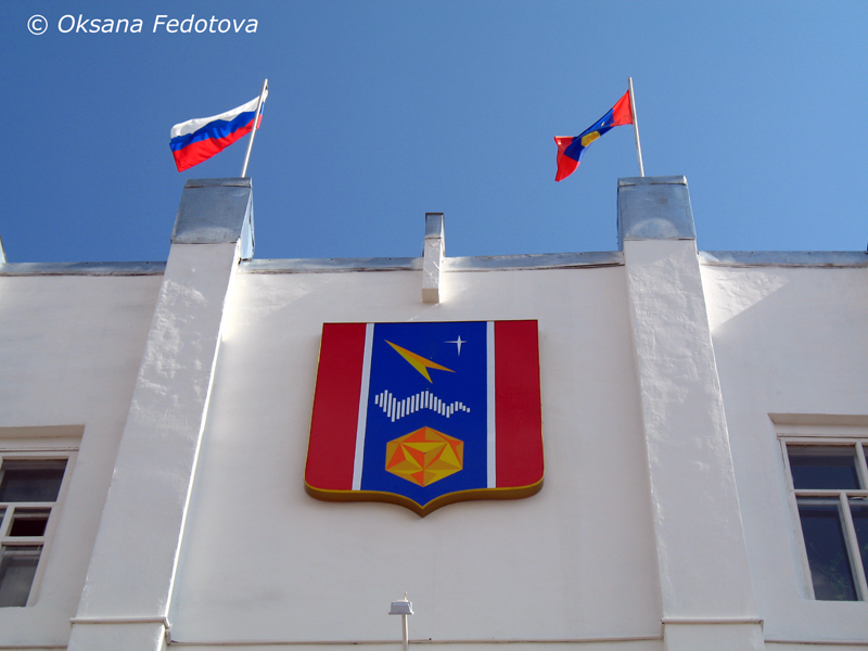 Wappen von Mirny am Gebäude der Stadtverwaltung